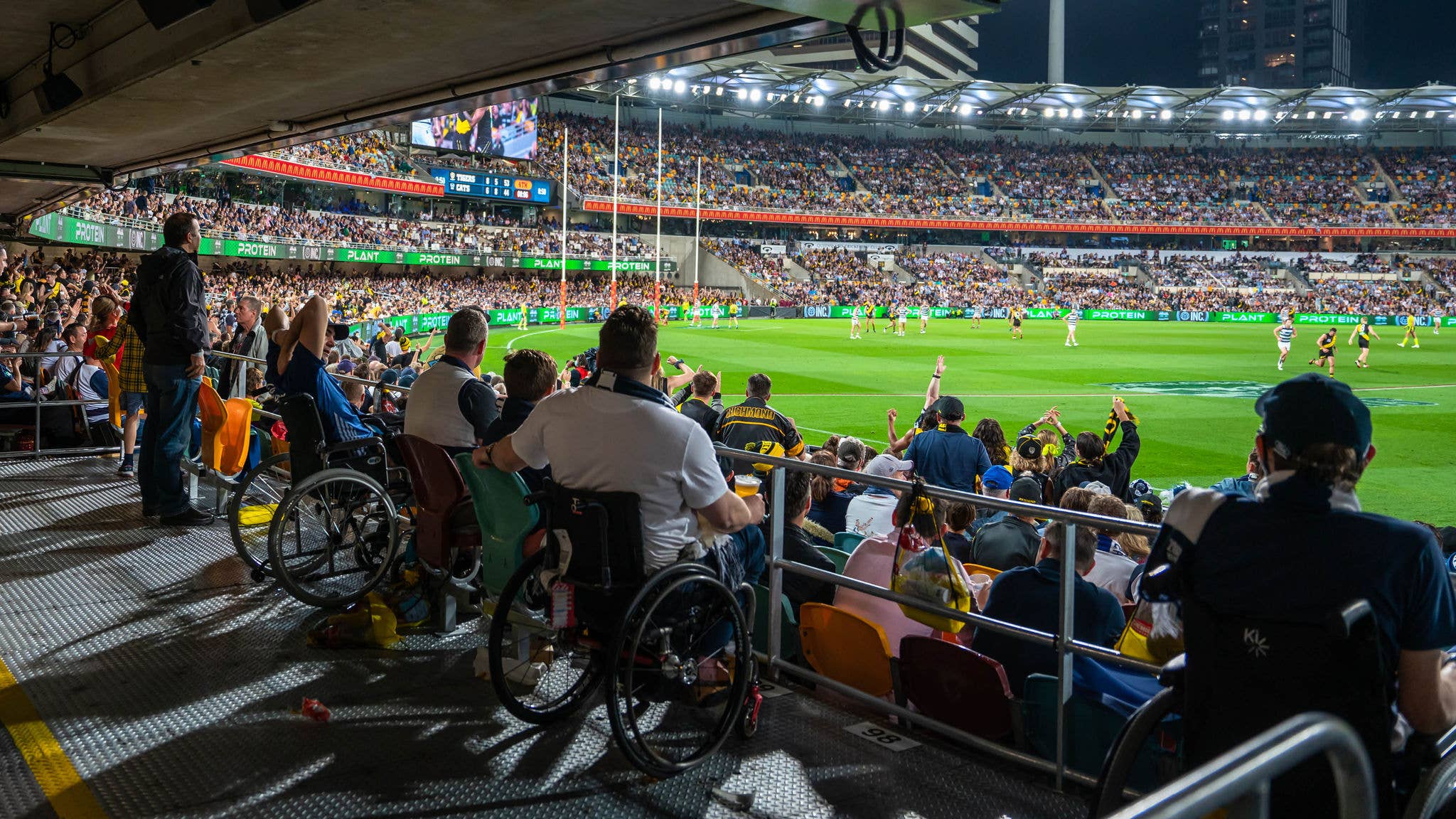 A road leads up to the lit up Gate 2 sign at the Gabba