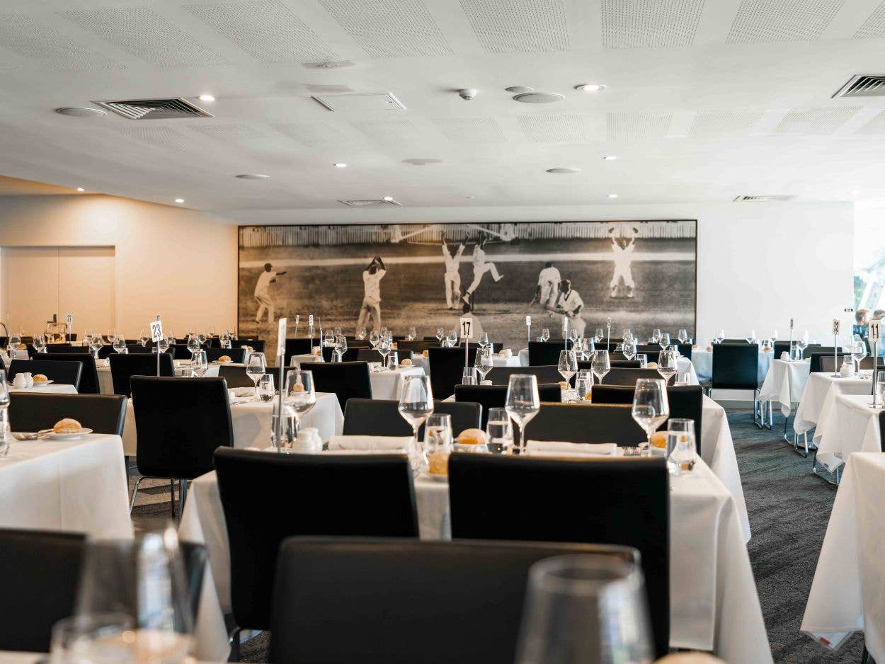 Dining tables set up with Gabba Members memorabilia in the background