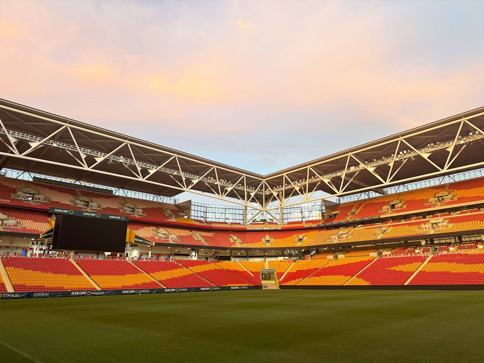 The inside of an empty Suncorp Stadium at dusk