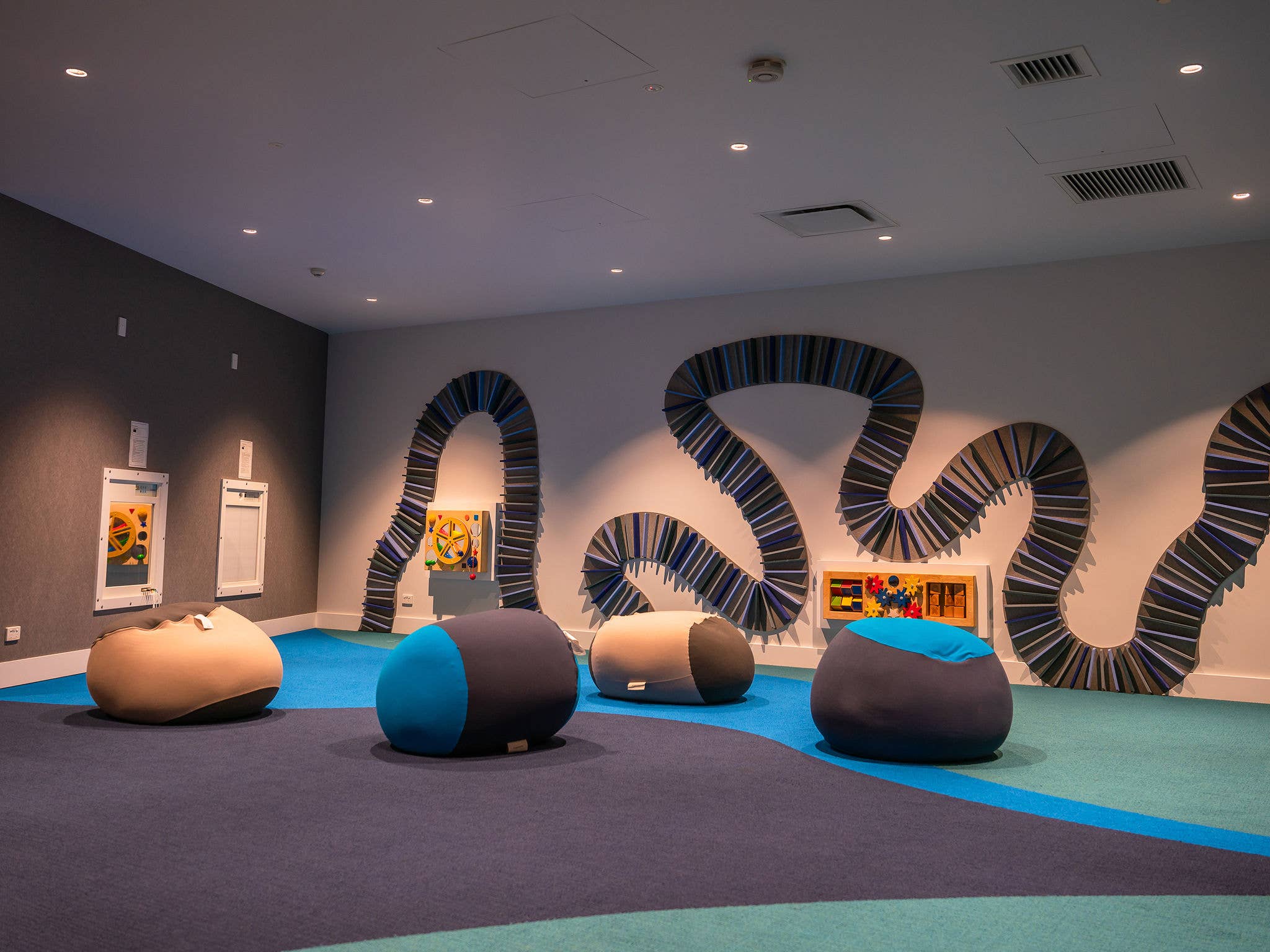 The interior of a quiet room with soft seating and low lights