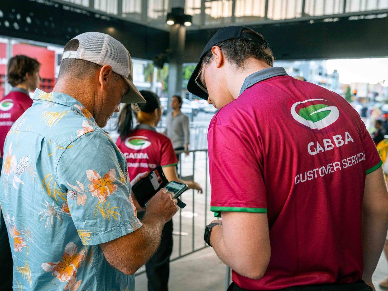 The Ashes CEDS assisting a customer with ticketing