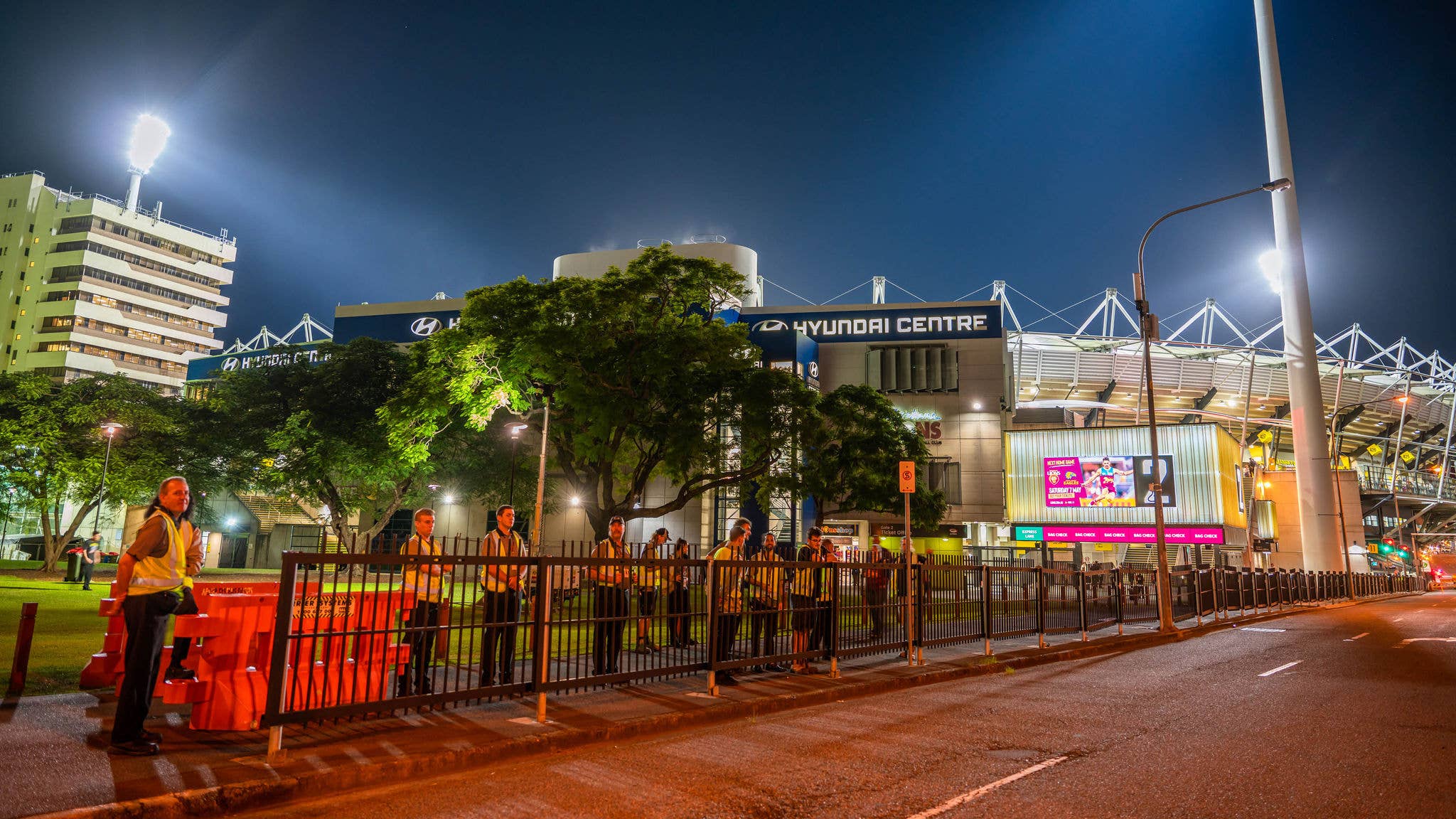 A road leads up to the lit up Gate 2 sign at the Gabba